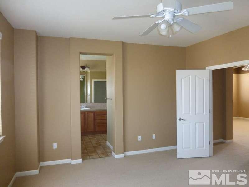 2471 Spring Flower Drive Reno, NV 89521 - Photo 10 of 20 an empty room with closet and a chandelier fan