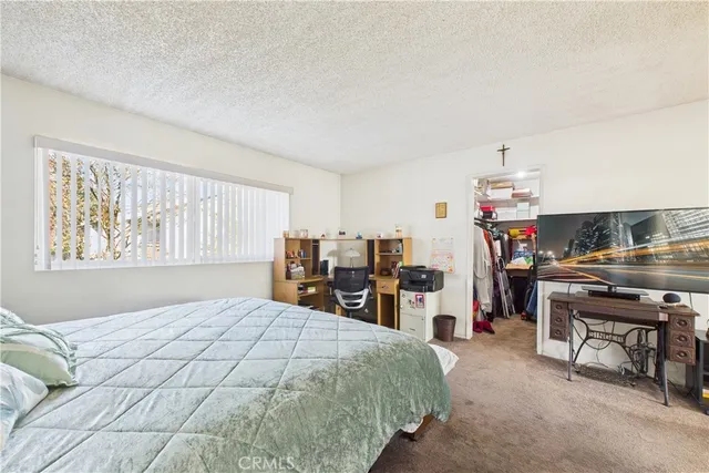 a bedroom with a bed and a desk