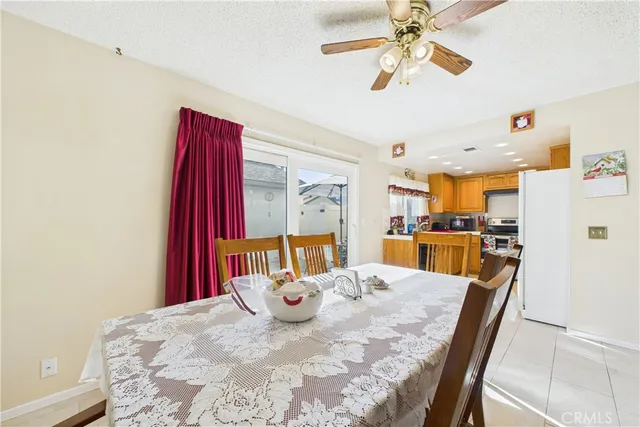a view of a dining room with furniture and a chandelier