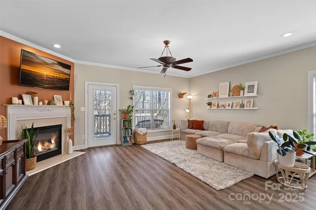 a living room with furniture fireplace and flat screen tv