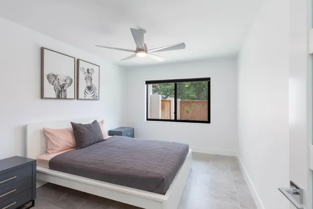 a bedroom with a bed and painting on the wall