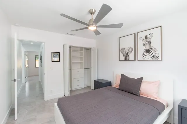 a bedroom with a large bed and a chandelier