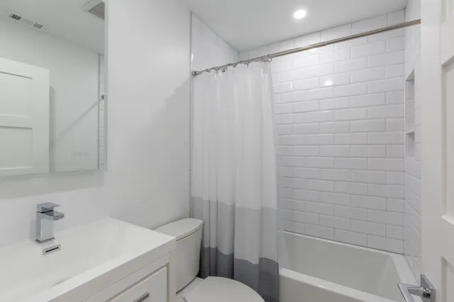 a bathroom with a shower and a sink