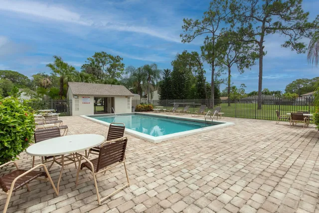 a view of house with backyard and outdoor seating
