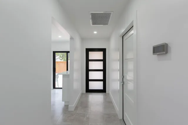 an empty room with windows and closet