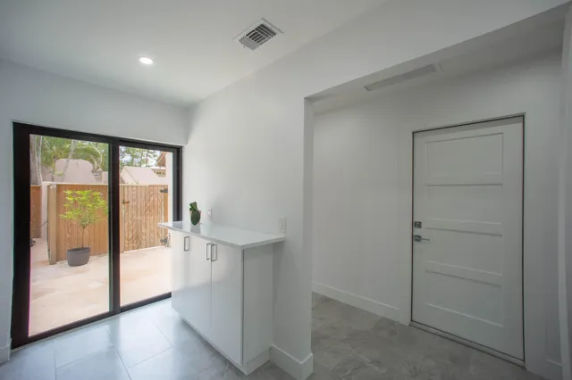 an empty room with wooden floor and door