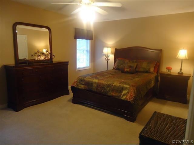 12619 Harrowgate Road Chester, VA 23831 - Photo 3 of 8 a bedroom with a bed and a mirror
