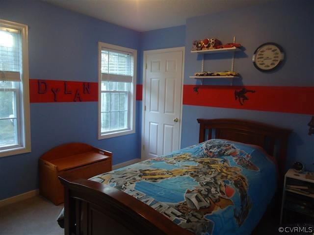 12619 Harrowgate Road Chester, VA 23831 - Photo 4 of 8 a bedroom with a bed and a window