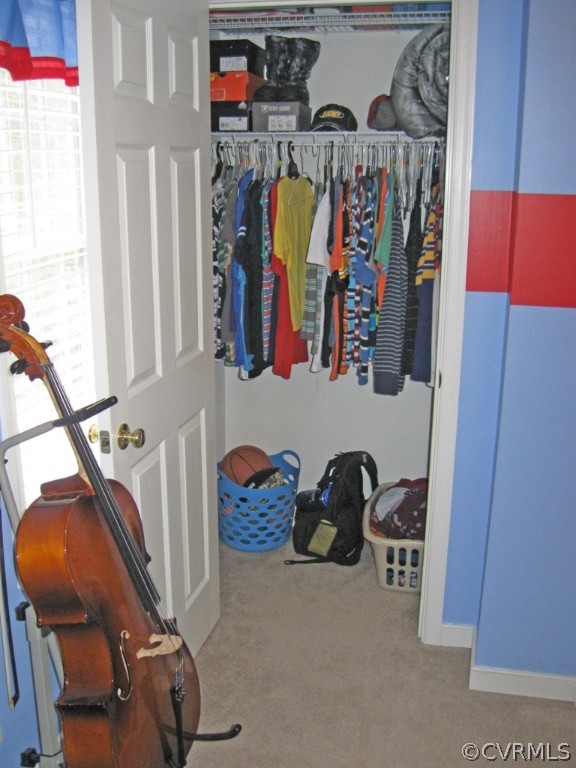 12619 Harrowgate Road Chester, VA 23831 - Photo 5 of 8 a view of walk in closet with clothes and shoes