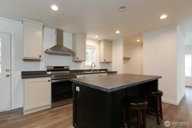 a kitchen with refrigerator cabinets and wooden floor