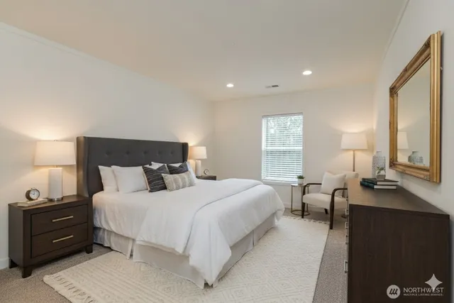 a bedroom with a bed and a night stand