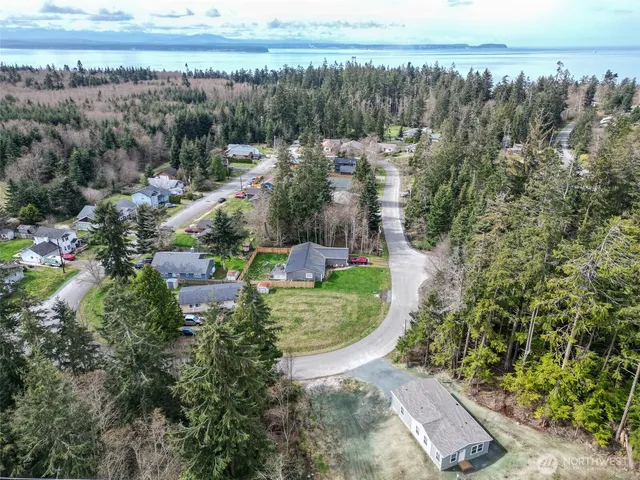 a aerial view of a house with a yard and sitting area