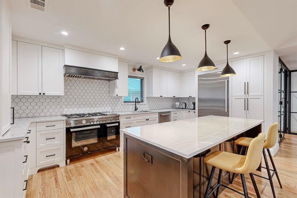 4423 Springside Lane Dallas, TX 75214 - Photo 15 of 40 a kitchen with a stove a sink a refrigerator and a wooden floor
