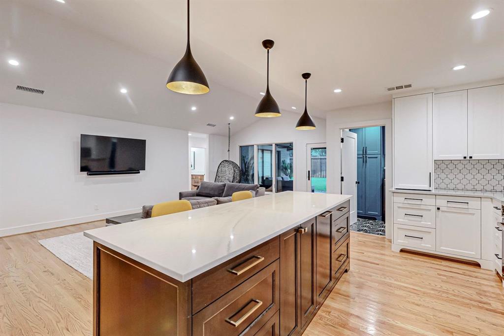 4423 Springside Lane Dallas, TX 75214 - Photo 16 of 40 a kitchen with stainless steel appliances kitchen island granite countertop a stove a sink and a refrigerator