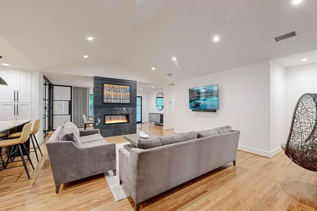 a living room with furniture and wooden floor