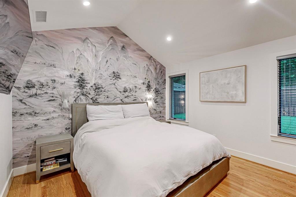 4423 Springside Lane Dallas, TX 75214 - Photo 20 of 40 a bedroom with a bed and a wooden floor