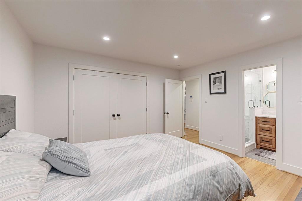 4423 Springside Lane Dallas, TX 75214 - Photo 28 of 40 a bedroom with a bed and cabinets