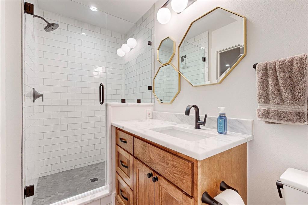 4423 Springside Lane Dallas, TX 75214 - Photo 29 of 40 a bathroom with a sink vanity granite and a mirror