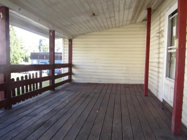 a view of a porch with wooden floor