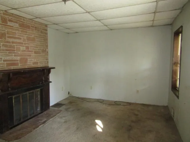 a view of empty room with fireplace