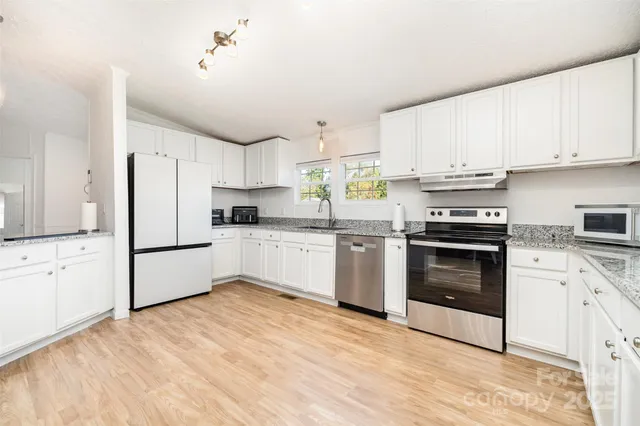 a kitchen with a white cabinets and white appliances