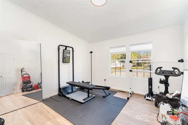 a living room with furniture and floor to ceiling window