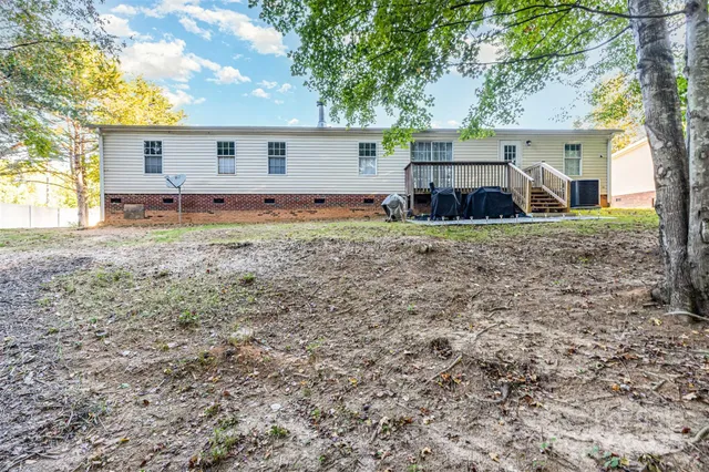 a view of a house with backyard and chairs