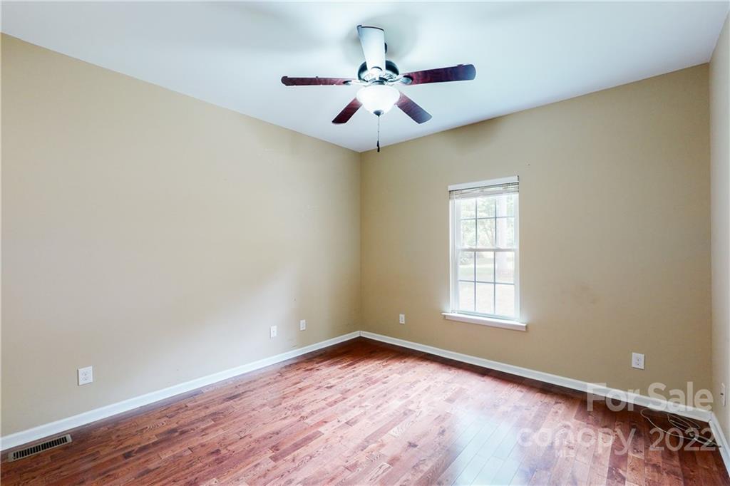 140 Beaver Dam Road Badin Lake, NC 28127 - Photo 19 of 40 wooden floor in an empty room with a window