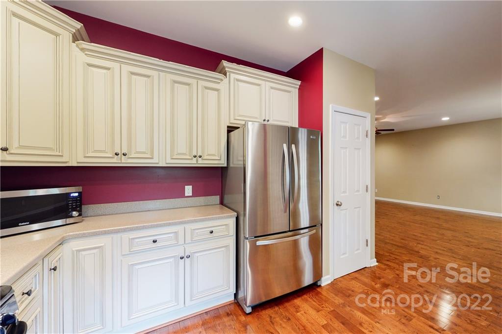 140 Beaver Dam Road Badin Lake, NC 28127 - Photo 10 of 40 a kitchen with stainless steel appliances a refrigerator and cabinets