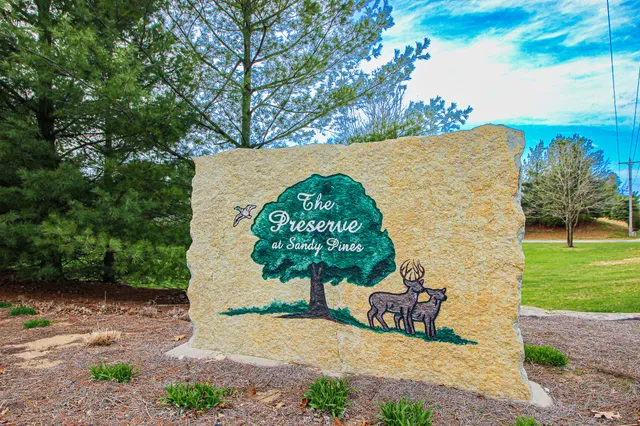 a view of a back yard of the house and a bench