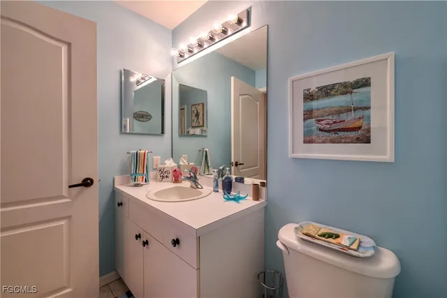 a bathroom with a sink mirror and toilet