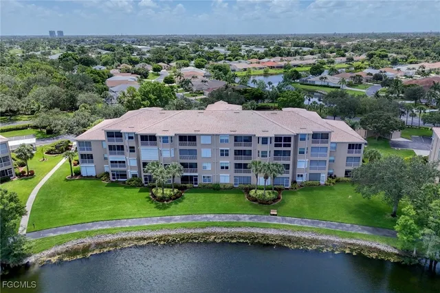an aerial view of a house with a garden and lake view