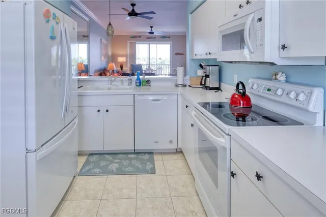 a kitchen with a sink cabinets and window
