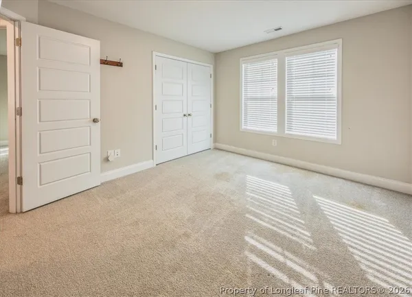 an empty room with closet area