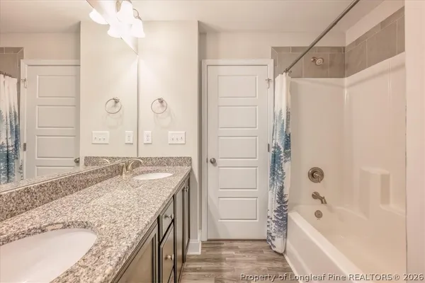 a bathroom with a granite countertop sink a toilet and a large mirror