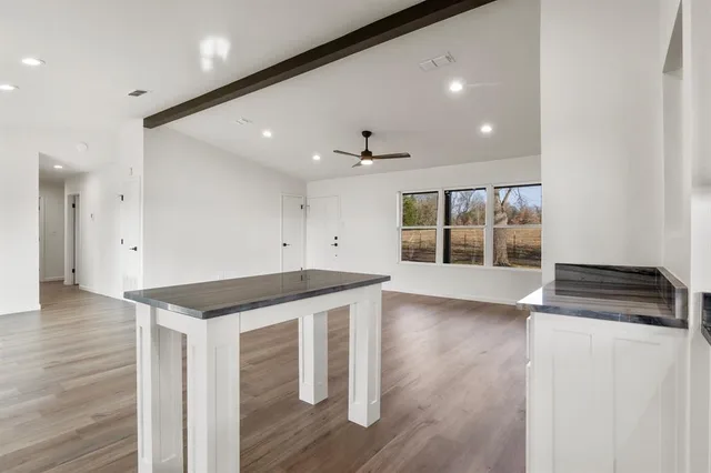 a kitchen with stainless steel appliances granite countertop a sink and a stove