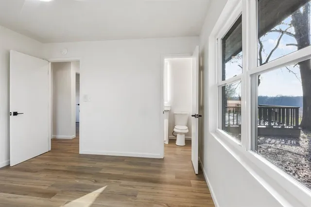 a view of an entryway with wooden floor and a livingroom