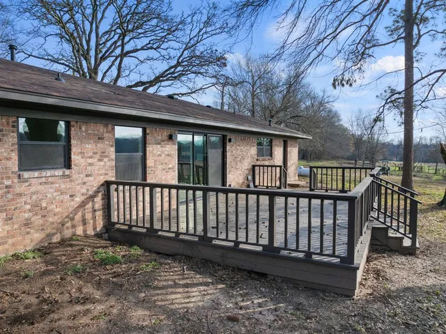 a view of a wooden deck and a yard