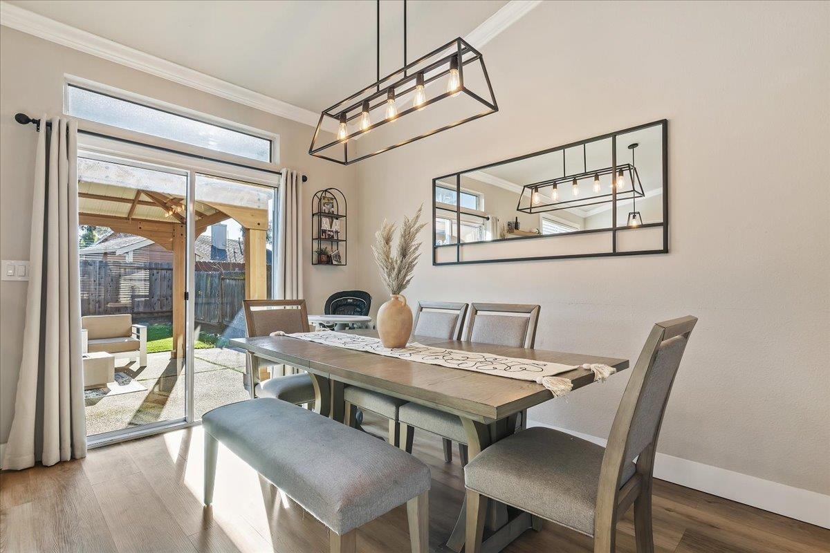 1105 Deerpark Road Oakley, CA 94561 - Photo 11 of 25 Dining area featuring crown molding, healthy amount of natural light, and wood finished floors