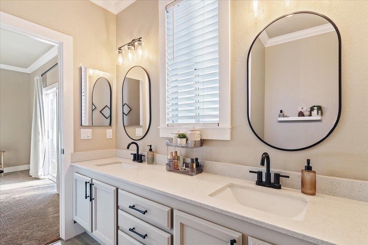1105 Deerpark Road Oakley, CA 94561 - Photo 16 of 25 Full bath featuring crown molding, double vanity, light carpet, and a textured wall
