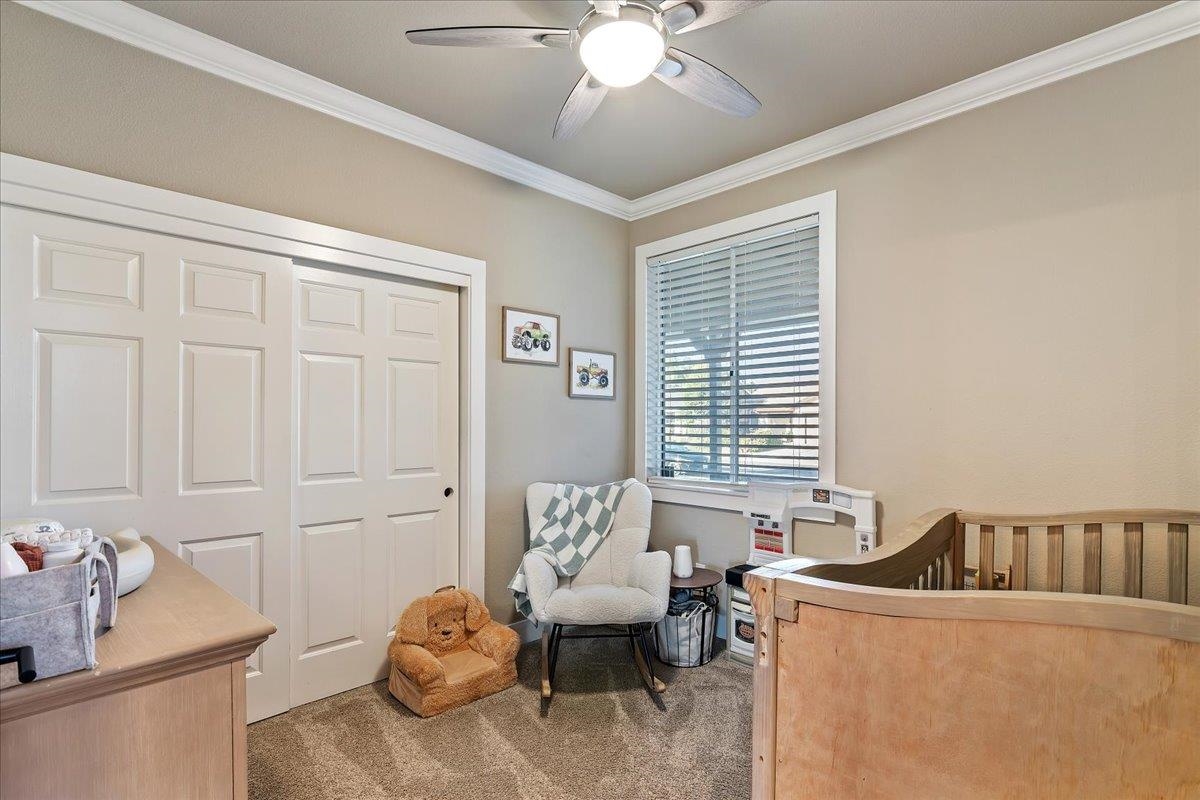 1105 Deerpark Road Oakley, CA 94561 - Photo 18 of 25 Carpeted bedroom featuring ornamental molding, a closet, a nursery area, and a ceiling fan