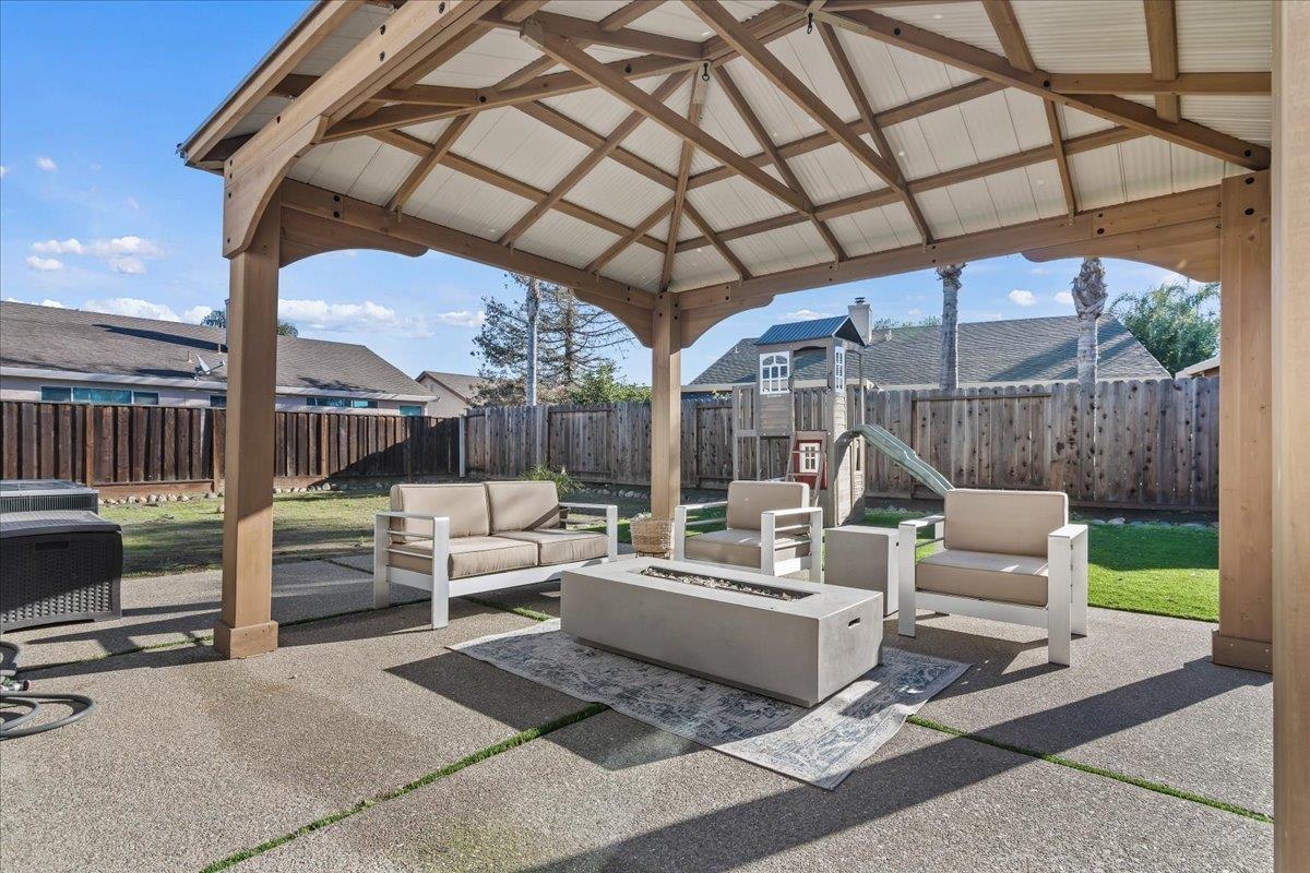 1105 Deerpark Road Oakley, CA 94561 - Photo 23 of 25 Fenced backyard featuring an outdoor living space with a fire pit, a patio area, and a gazebo
