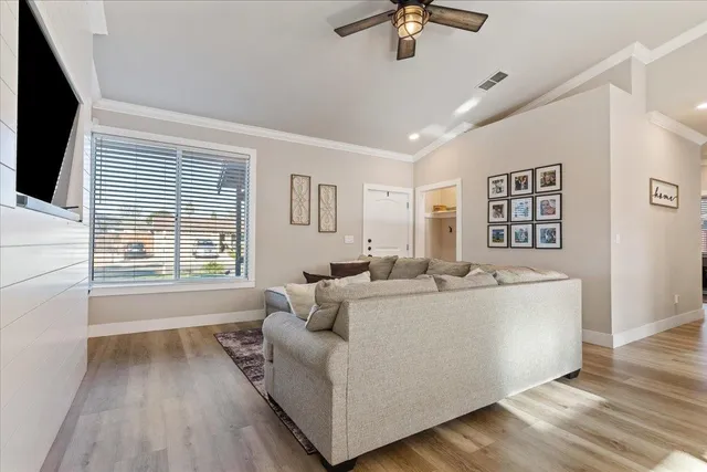 a living room with furniture and a flat screen tv