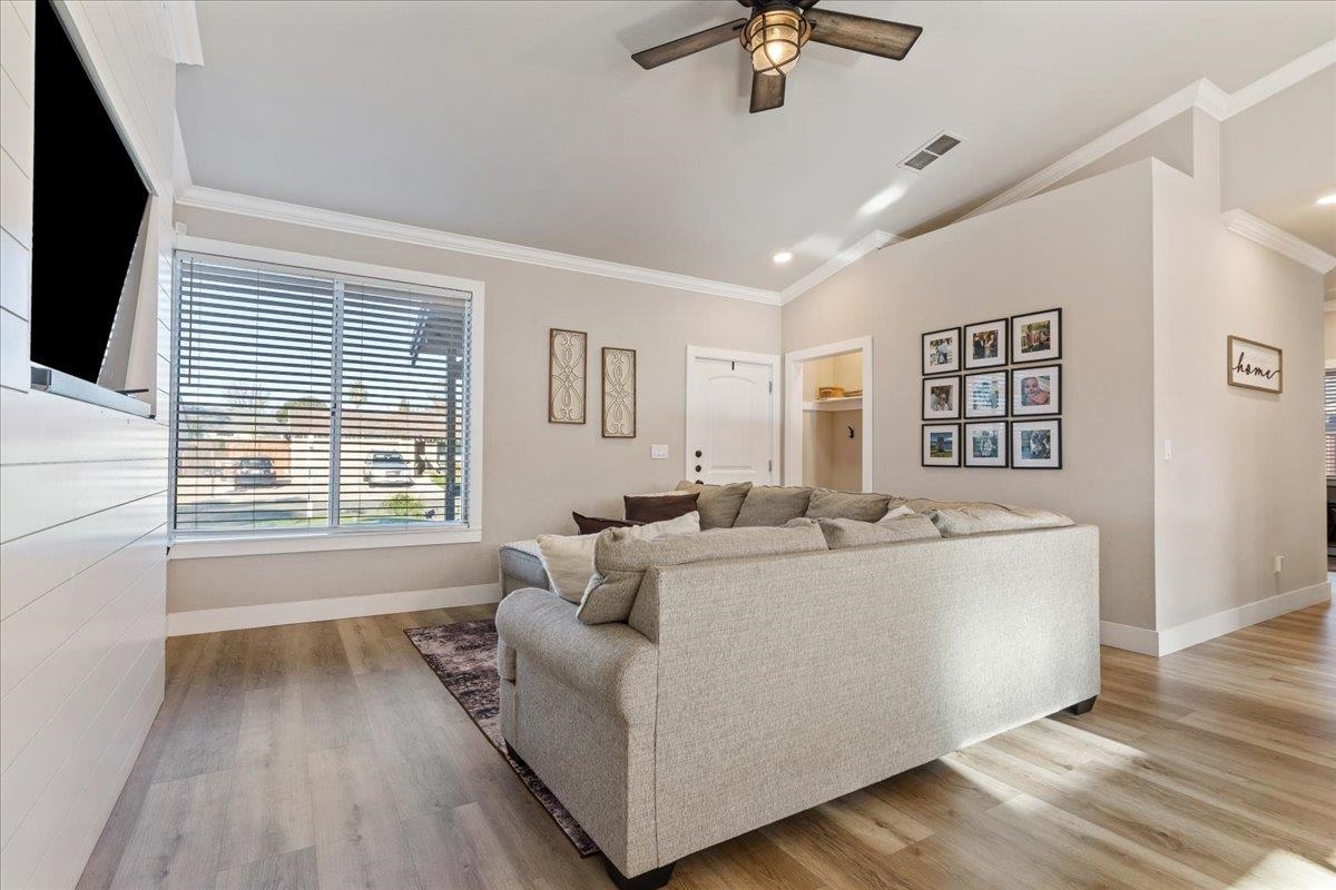 1105 Deerpark Road Oakley, CA 94561 - Photo 5 of 25 Living room featuring vaulted ceiling, ornamental molding, light wood-type flooring, and a ceiling fan