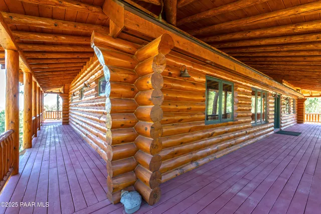 a living room with wooden floors and kitchen view