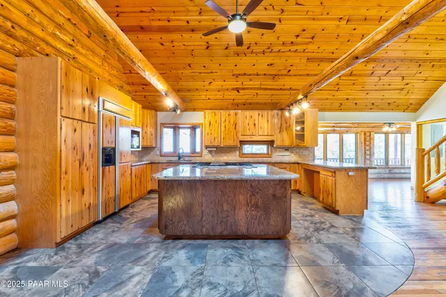 a kitchen with stainless steel appliances granite countertop a sink and a stove