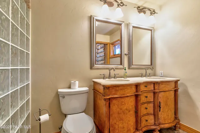 a bathroom with a granite countertop tub sink and mirror