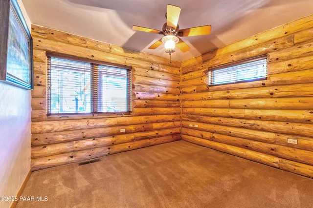 a bathroom with a granite countertop sink and a window