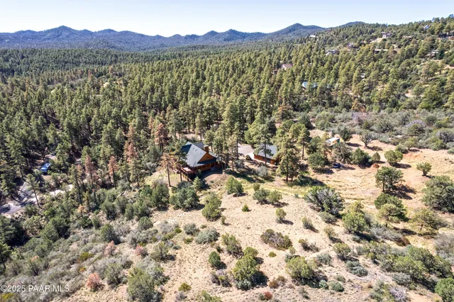 a view of a lush green hillside and a building