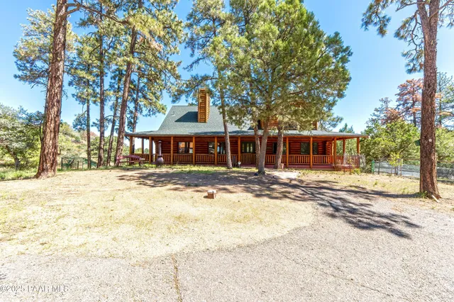 a front view of a house with a yard covered with snow